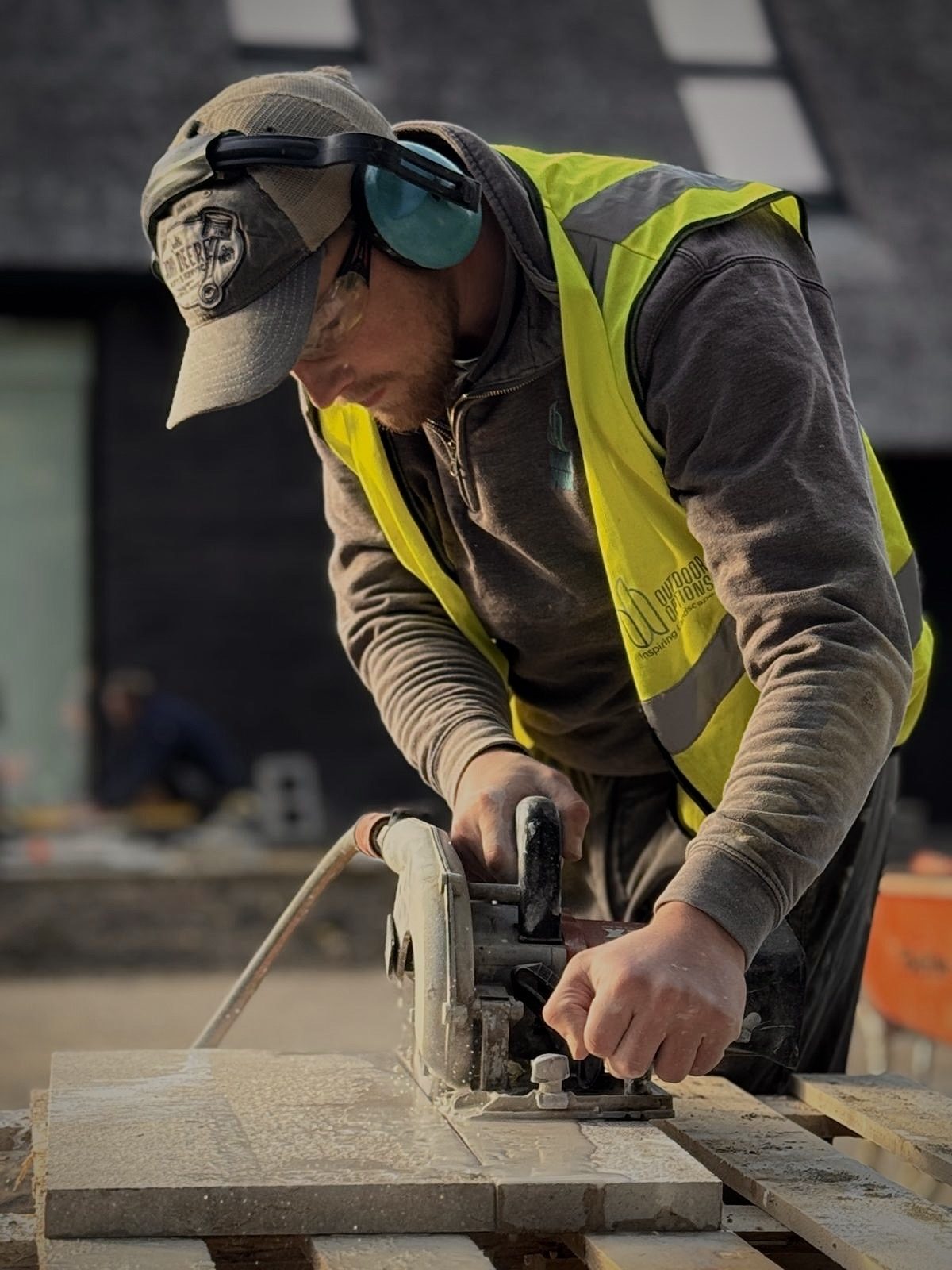 Crew member cutting paving on site